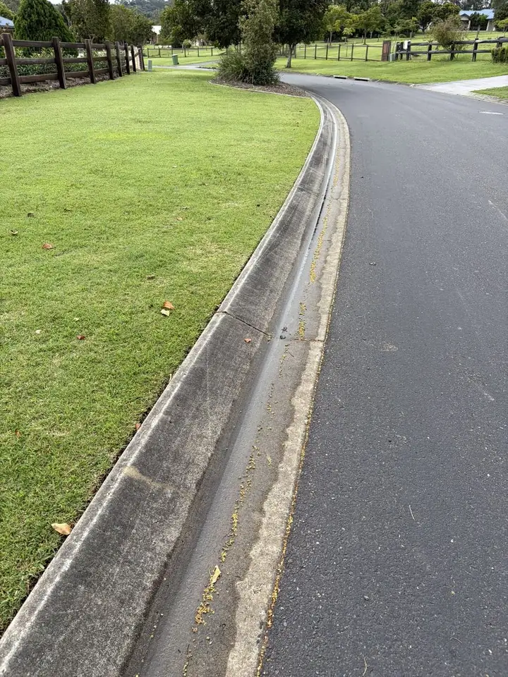 Concrete kerb and gutter in brisbane before pressure cleaning